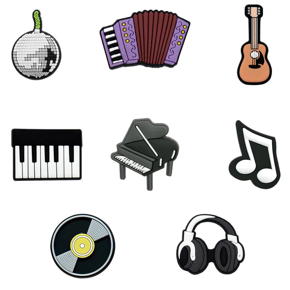 Set of musical instrument shoe charms including a disco ball, accordion, guitar, keyboard, piano, vinyl record, and headphones on a white background.