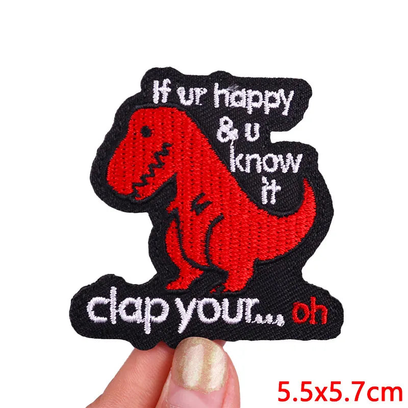 Red dinosaur patch with text held by a hand on a white background