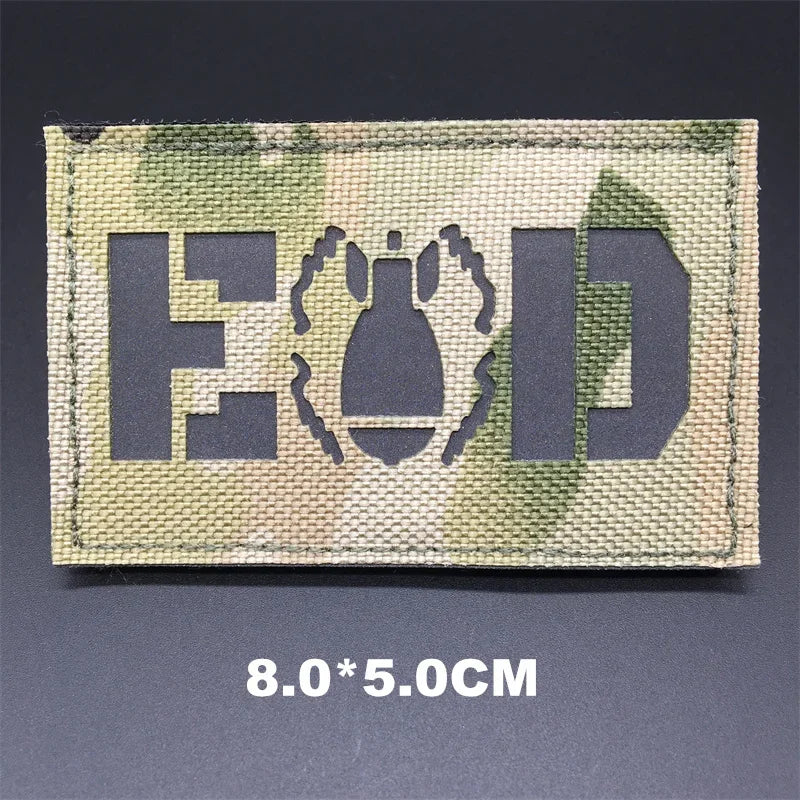 Multicam EOD patch with text and symbol on a dark background