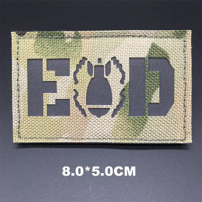 Multicam EOD patch with text and symbol on a dark background
