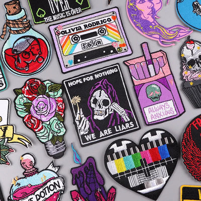 Collection of various colorful patches with different designs on a gray background