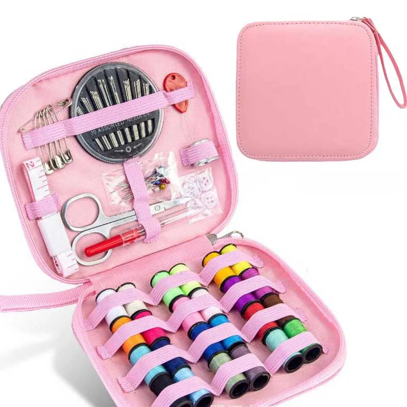 Pink sewing kit with various sewing supplies on a white background