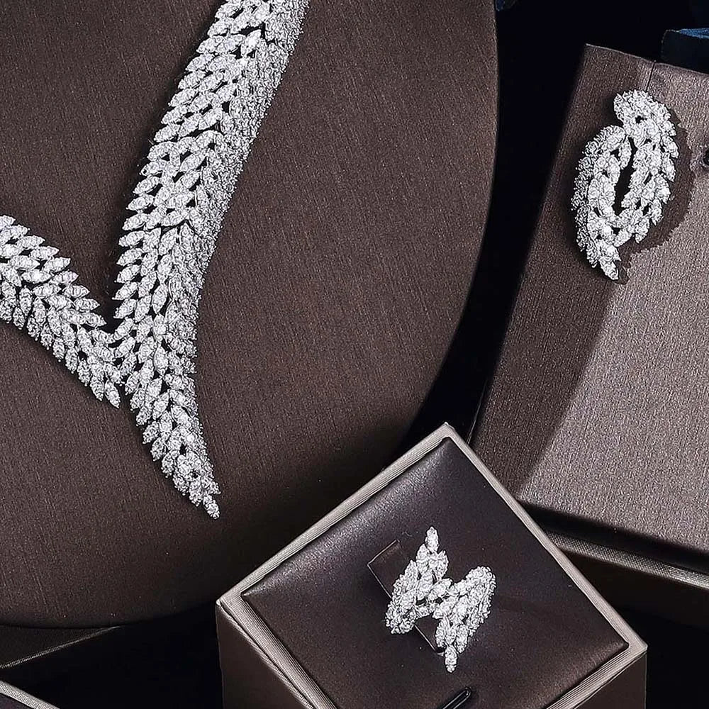 Silver jewelry set on brown fabric with a box