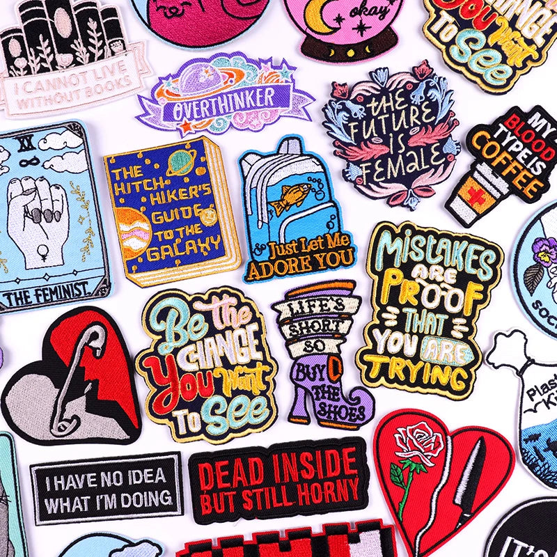 Collection of colorful patches with various designs and text on a white background