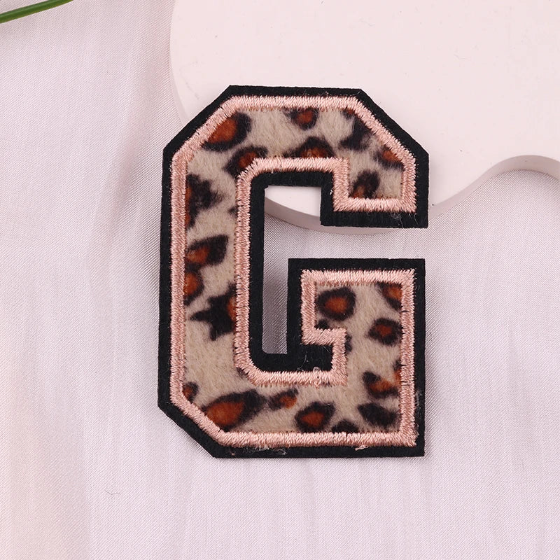 Leopard print letter 'G' patch on a white background