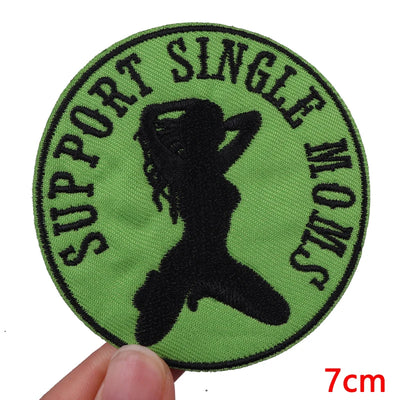 Circular patch with silhouette of a woman and text 'Support Single Moms' on a green background.