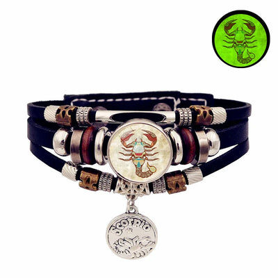 Multistrand bracelet with zodiac charm on a white background