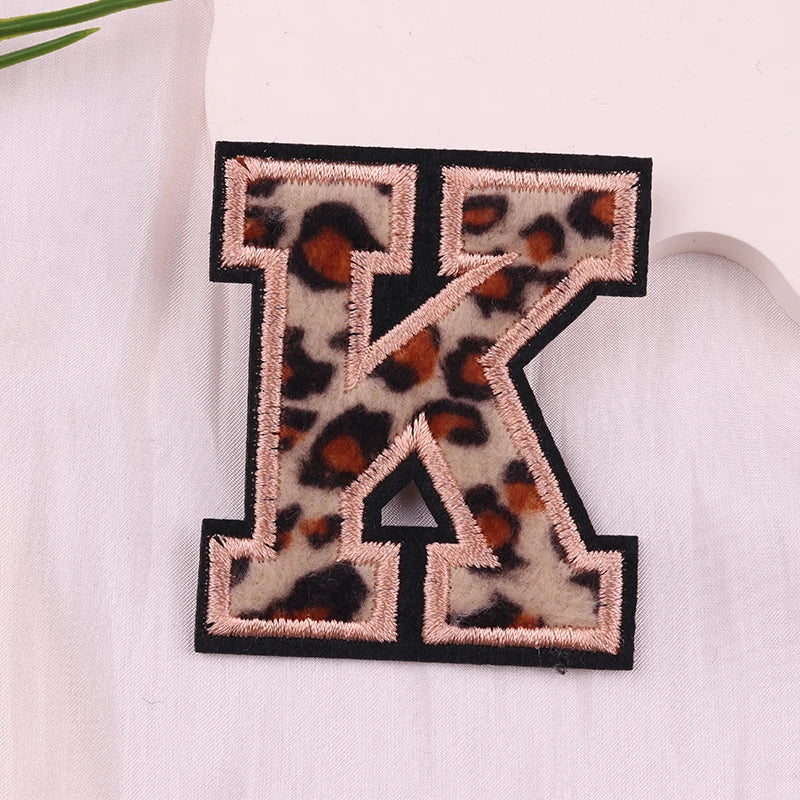 Leopard print letter 'K' patch on a white background