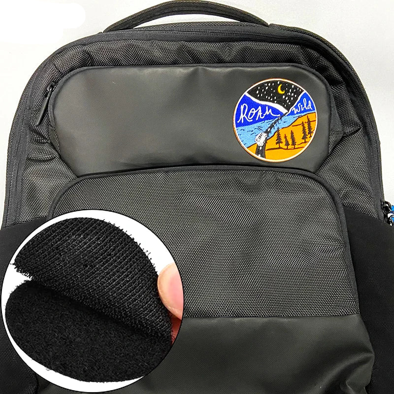 Black backpack with a colorful patch on the back and a close-up of the patch's texture.