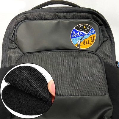 Black backpack with a colorful patch on the back and a close-up of the patch's texture.