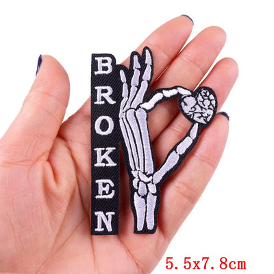 Patch with skeleton hand and 'BROKEN' text held in a hand, size 5.5x7.8cm.