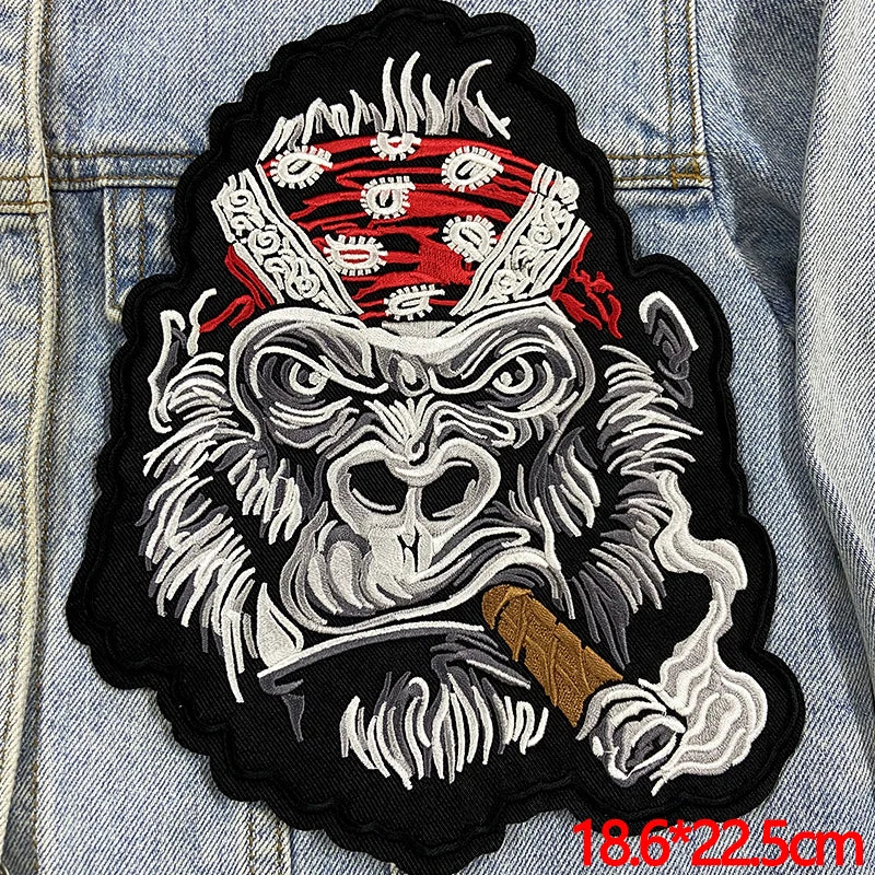 Embroidered patch of a monkey with an American flag headband on denim fabric