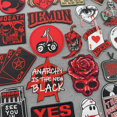 Collection of various red and black patches on a gray background