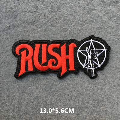 Rush band patch with red text and white star on gray fabric