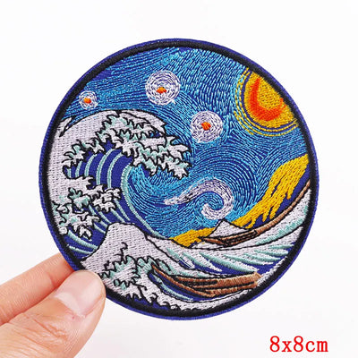 Circular embroidered patch with wave design held by a hand on a white background