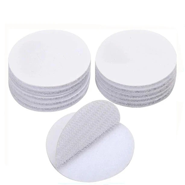 Set of White Velcro circular adhesive pad  on a light gray background
