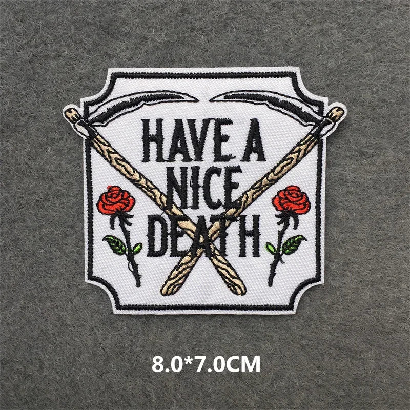 Embroidered patch with 'Have a Nice Death' text and roses on a gray background