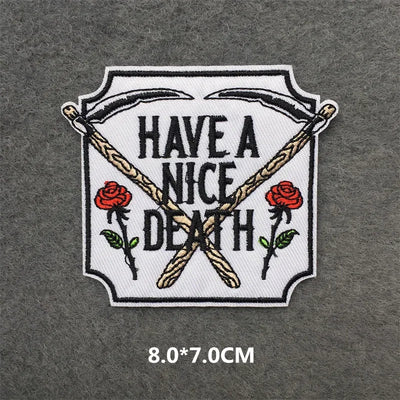 Embroidered patch with 'Have a Nice Death' text and roses on a gray background