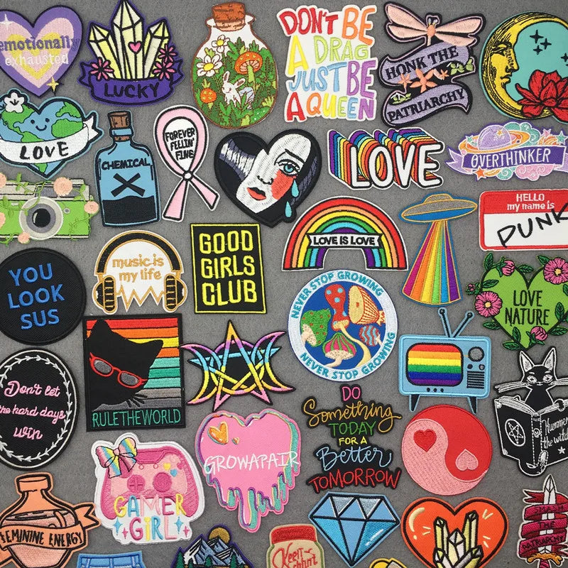 Collection of colorful stickers with various designs and text on a gray background