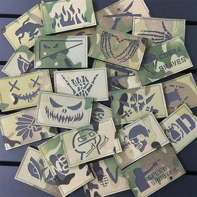 Collection of camouflage and tactical patches on a dark surface