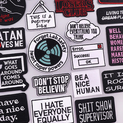 Collection of various patches with text and graphics on a white background