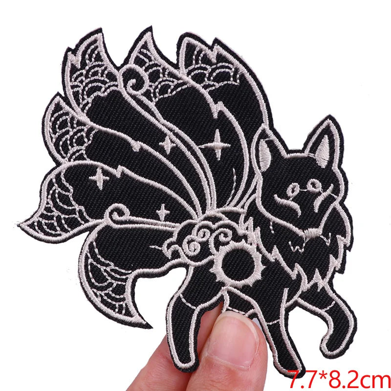 Decorative patch with a wolf design held by a hand on a white background