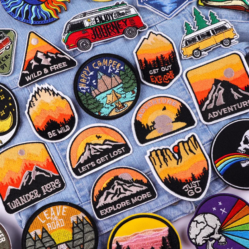 Collection of outdoor-themed patches on a denim fabric background