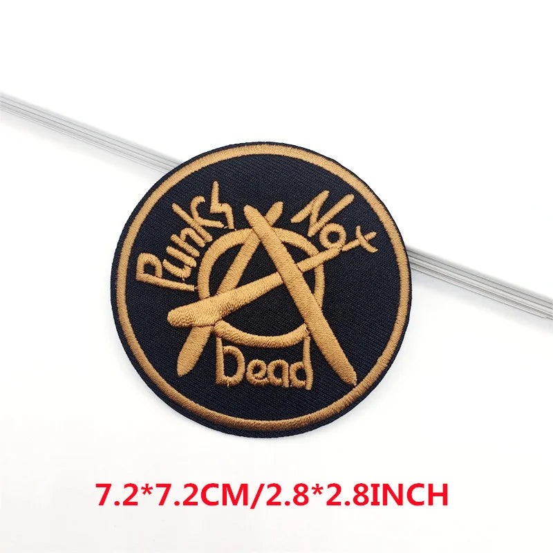 Embroidered patch with 'Punks Not Dead' text and symbol on a black background