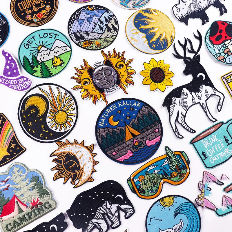 Collection of various embroidered patches with different designs on a white background