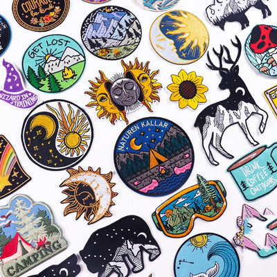 Collection of various embroidered patches with different designs on a white background