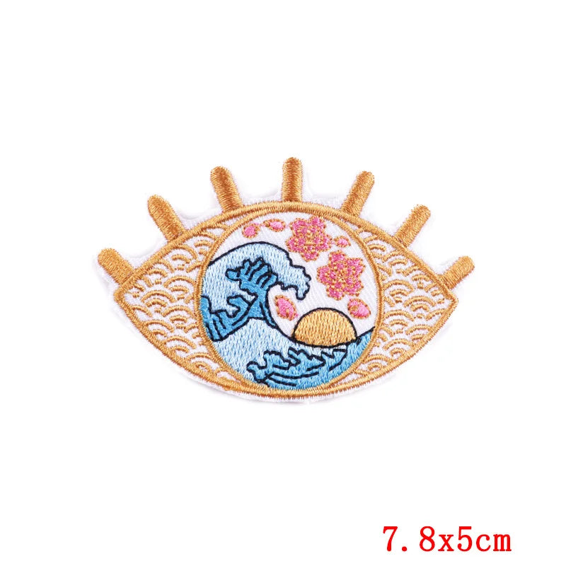Embroidered patch with eye design and wave pattern on a white background