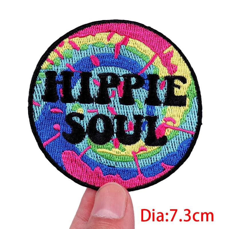 Colorful patch with 'Hippie Soul' text held by a hand, on a white background.
