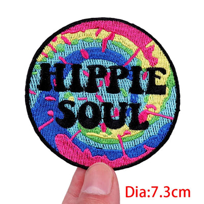 Colorful patch with 'Hippie Soul' text held by a hand, on a white background.
