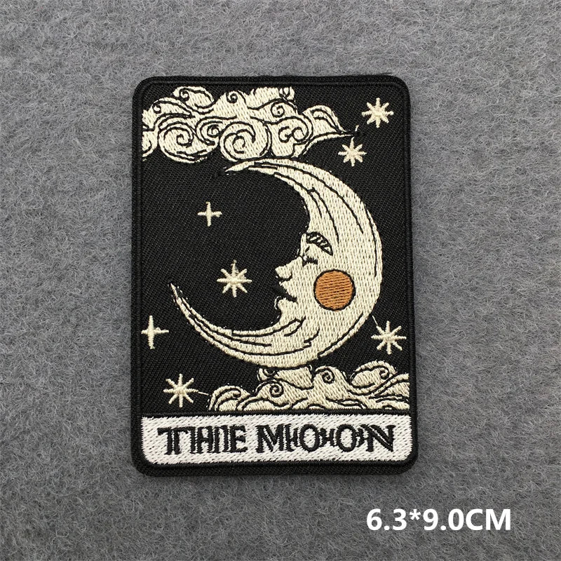 Embroidered patch with moon and star design on a gray background