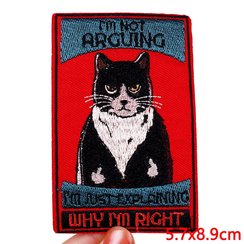 Embroidered patch with a cat illustration and text on a red background