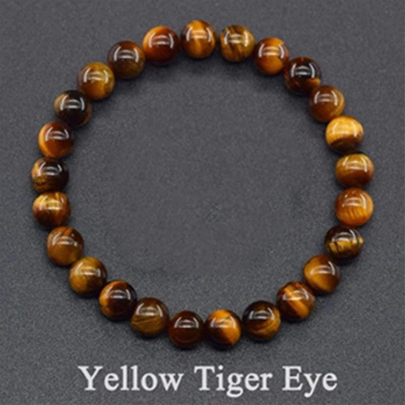 Yellow tiger eye beaded bracelet on a gray background with &