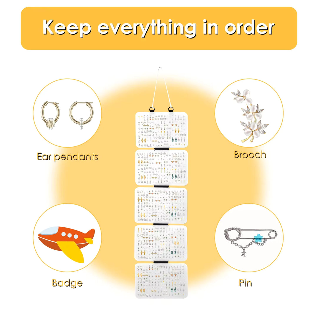 white  hanging organizer with compartments for earrings, brooches, badges, and pins on a yellow background.