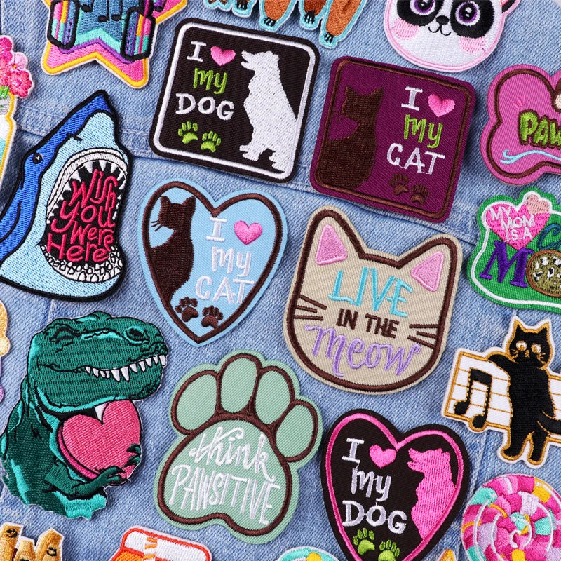 Collection of colorful patches with various designs on a denim background