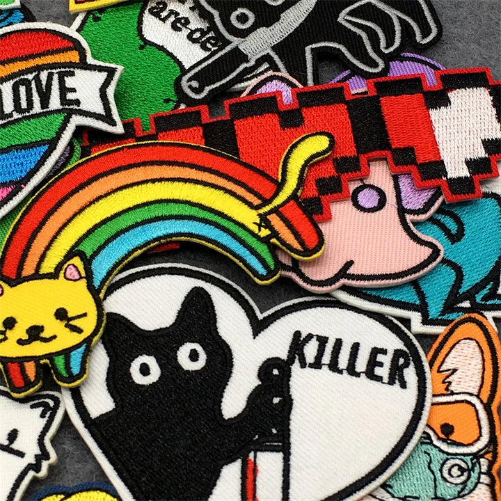 Collection of colorful patches with various designs including a rainbow, cat, and text.