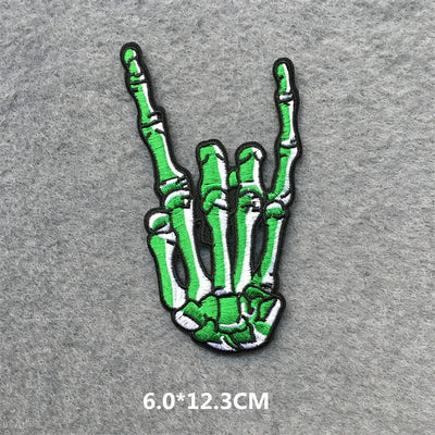Green skeleton hand patch on a gray background