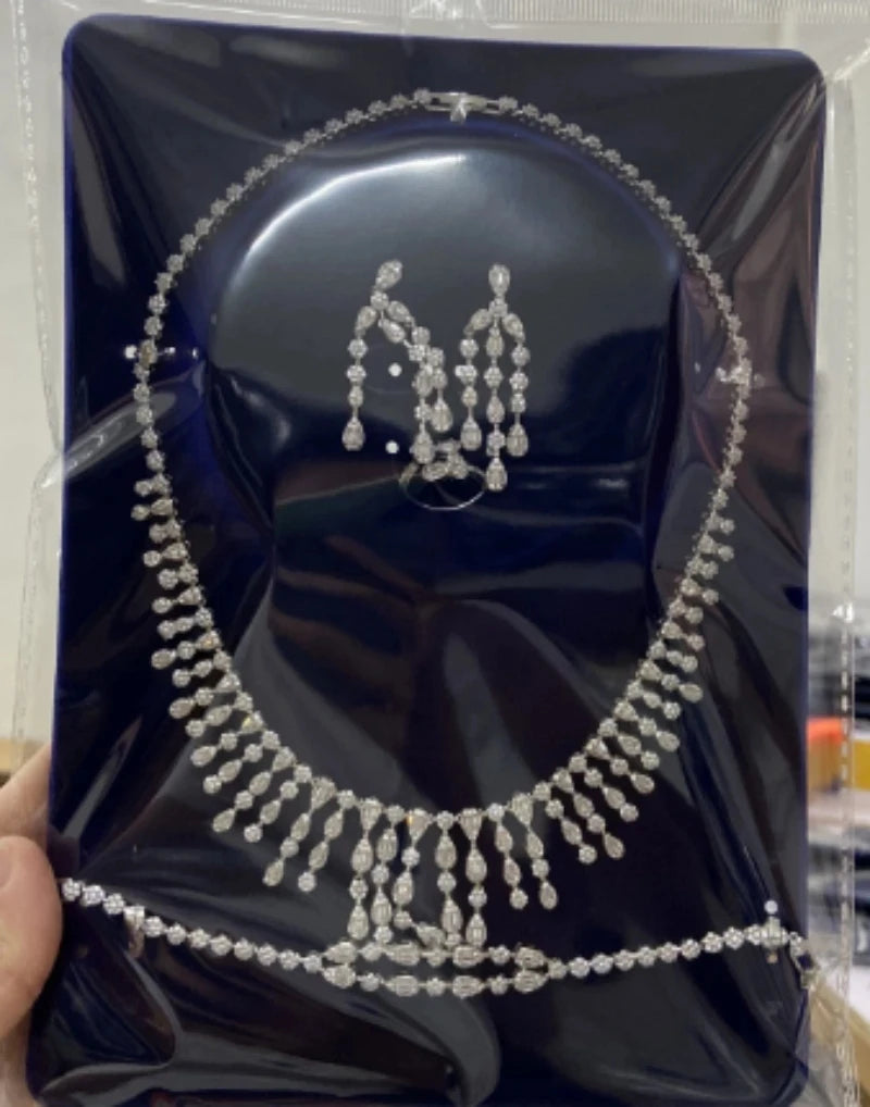 Necklace bracelet and earrings set on a blue display card