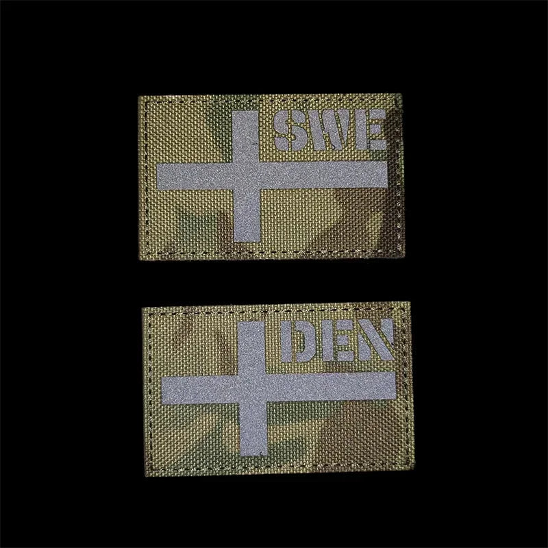 Two tactical patches with cross symbols and text on a black background