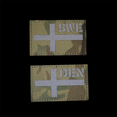Two tactical patches with cross symbols and text on a black background