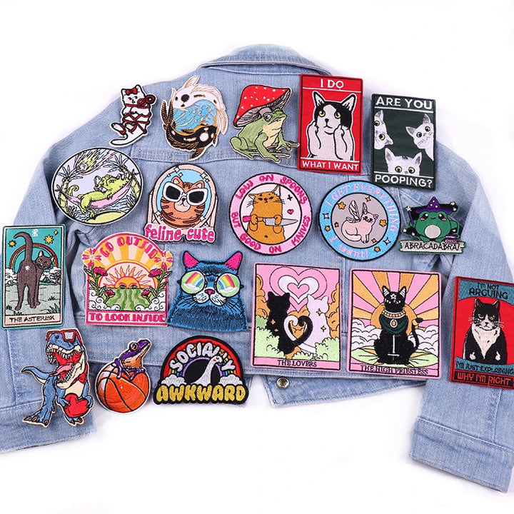 Denim jacket with various colorful patches on a white background