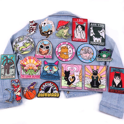 Denim jacket with various colorful patches on a white background