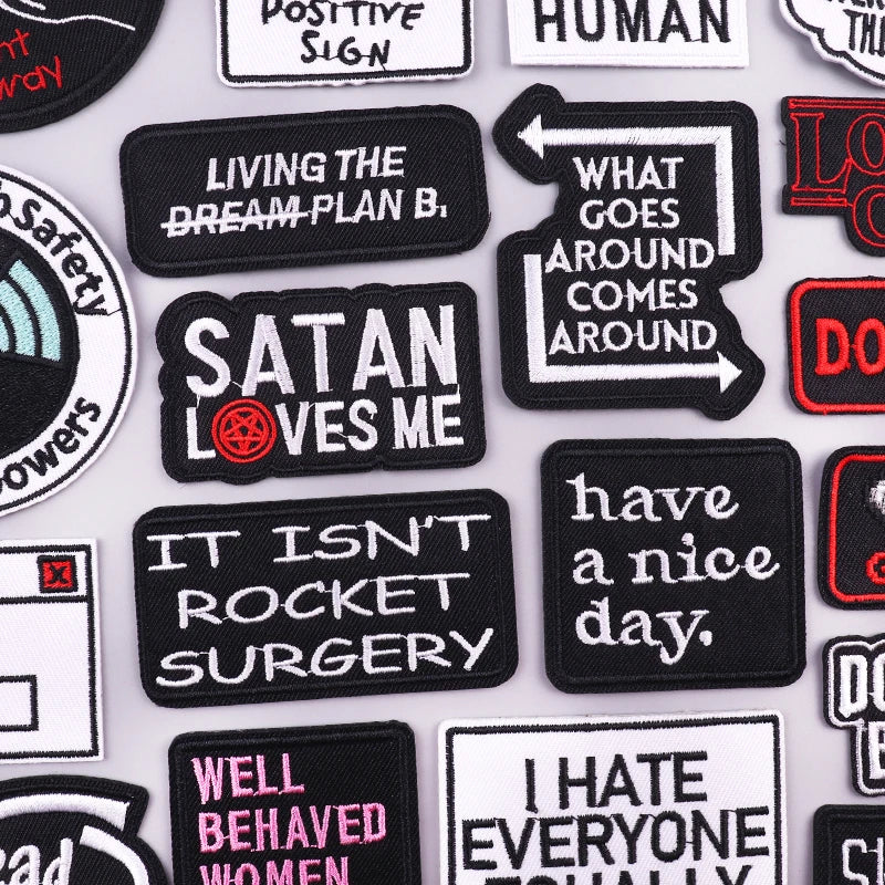 Collection of various text-based patches on a white background