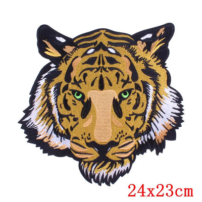 Embroidered patch of a tiger's head with green eyes on a white background, size 24x23cm.