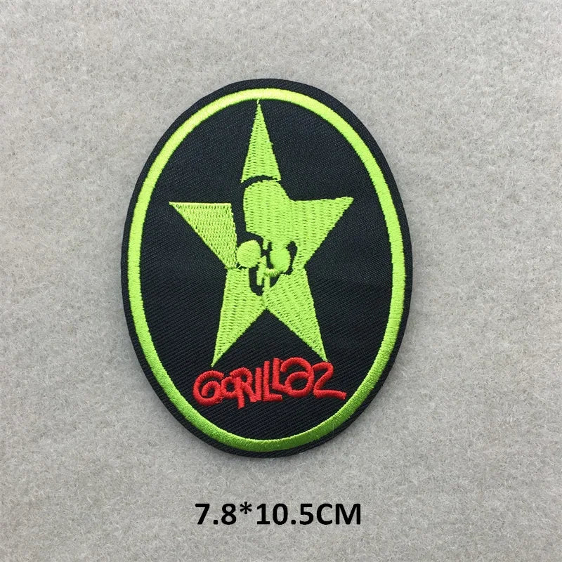 Embroidered patch with a green star and red text on a gray background