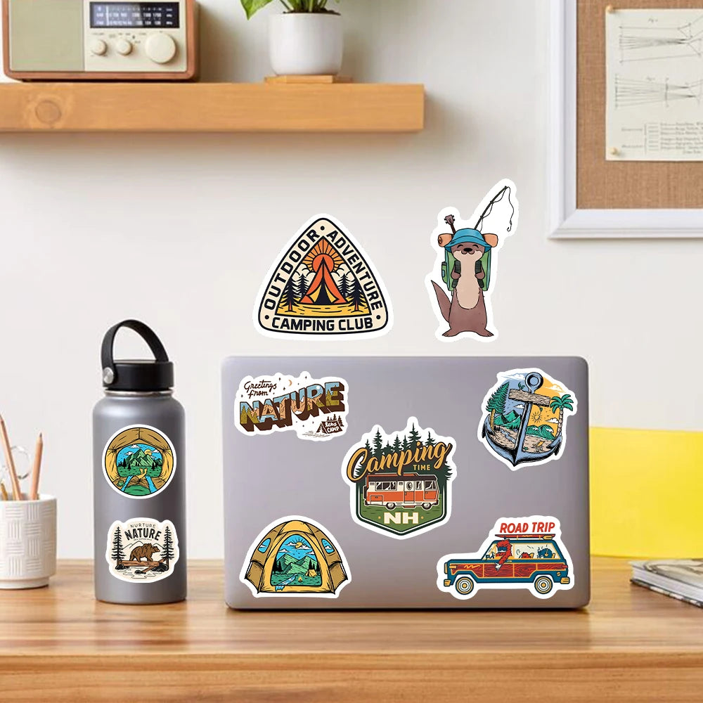 Laptop with nature-themed stickers on a desk next to a water bottle