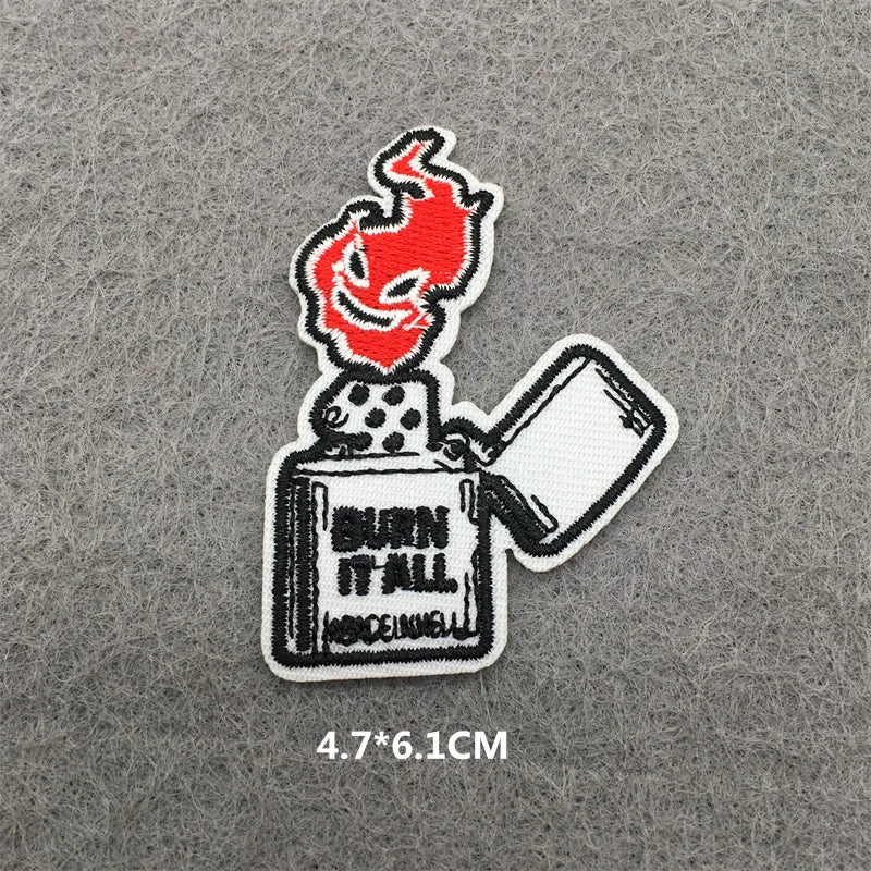 Embroidered patch of a lighter with flame design on a gray background